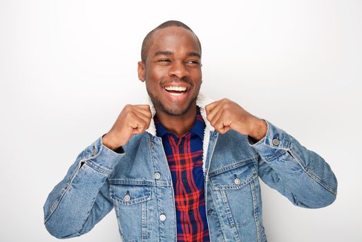 Portrait of cool young black male fashion model smiling with denim jacket
