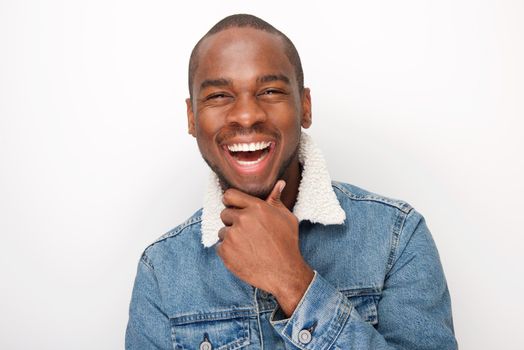 Close up happy young african american guy laughing with denim jacket