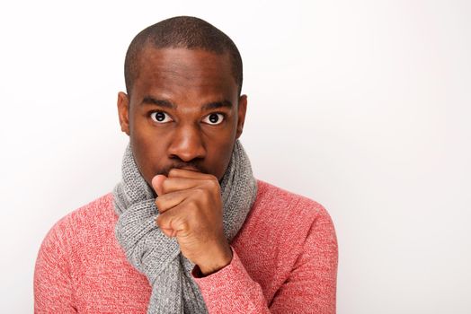 Close up young black man keeping warm with scarf 