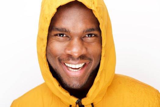 happy young black man with raincoat against isolated white background