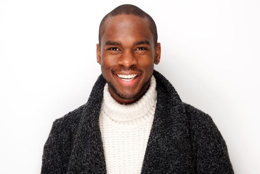 Close up smiling young black man with coat by isolated white background