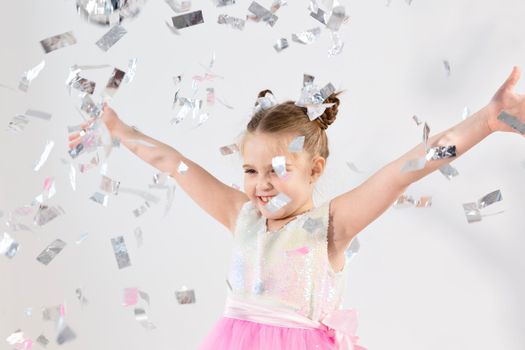 Party, holidays, new year and celebration concept - Female child throwing confetti