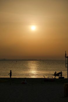 Rimini beach at sunset with yellow sky Riviera Romagnola. High quality photo