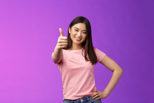 Good choice, well done. Pleased happy asian woman in pink t-shirt show thumb-up, approving like your idea, smiling joyfully, accept plan, agree, recommend product, give positive judgement