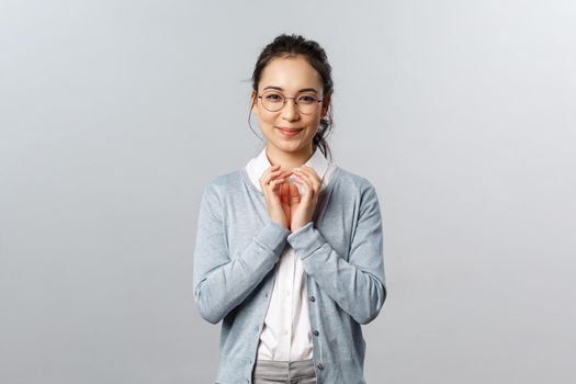 Lifestyle, people and emotions concept. Have great idea. Portrait of excited, pleased smart asian woman think-up plan, steeple fingers and smirk like genius, scheming something in mind