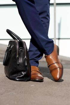 portrait of businessman legs and bag
