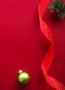 Christmas flatlay and holiday design concept. Decoration, ornament and xmas gift wrapping on red paper background as flat lay top view