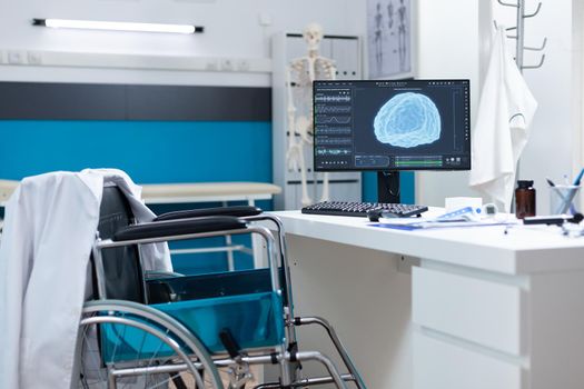 Modern empty hospital office having computer with brain radiography