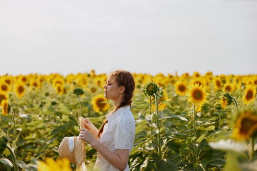 woman portrait looking in the sunflower field landscape. High quality photo