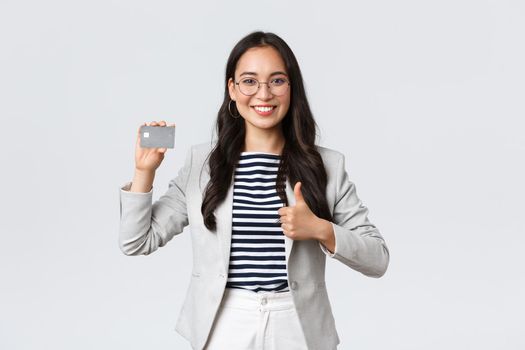 Business, finance and employment, entrepreneur and money concept. Professional female bank clerk, office manager recommend credit card, banking service, showing thumbs-up