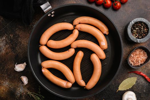 Raw sausage, on old dark rustic table background, top view flat lay