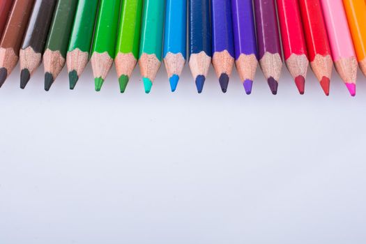  Color Pencils placed on a white background