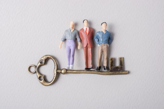 Tiny figurine of man model and retro key