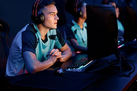 Young pro gamer participating in online tournament in gaming club