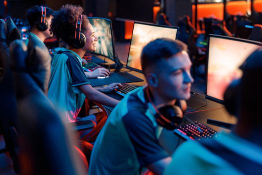 Skillful gamers practicing in gaming arena in internet club