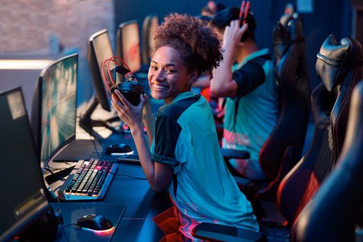 Cute woman gamer getting ready for game in computer club
