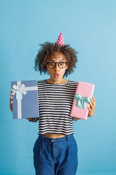 Multiracial young woman is holding birthday presents