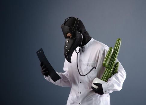 a doctor in a dressing gown, wearing a plague doctor mask with a cactus in his hands