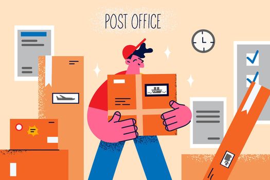 Smiling courier with parcel in post office