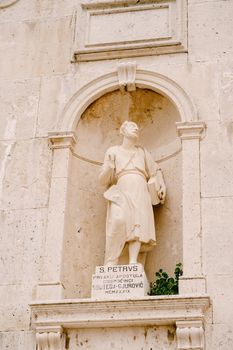Statue of St. Peter on the stone facade of the Church of the Nativity of the Virgin in Prcanj