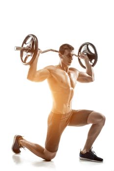 Mighty man standing on knee and holding barbell