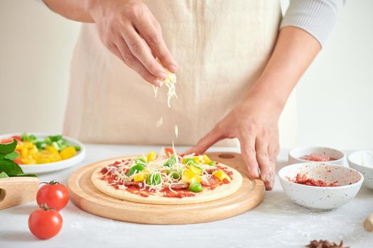 Step-by-step boss makes a pizza margarita. Dough and pizza ingredients