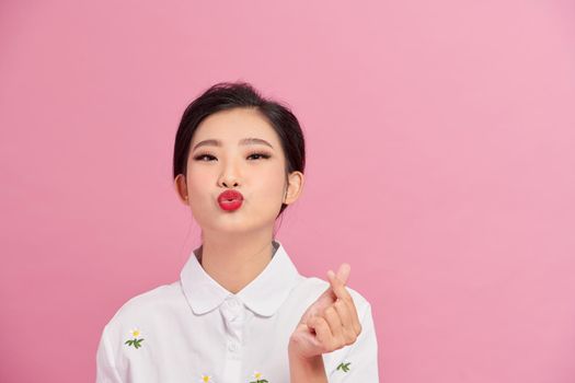 Asian young woman send air kiss. Valentine day and love concept.