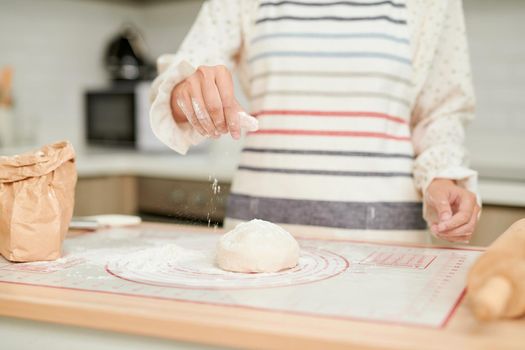 Woman hands kneading fresh dough for making bread