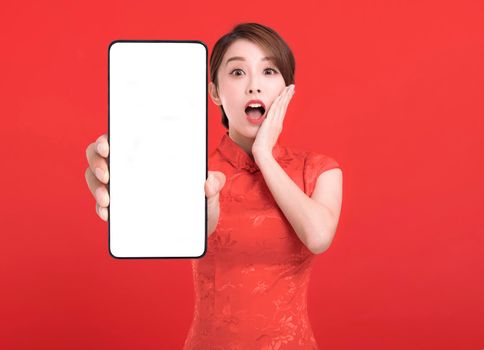 Happy chinese new year. suprised young Woman showing blank smart phone screen
