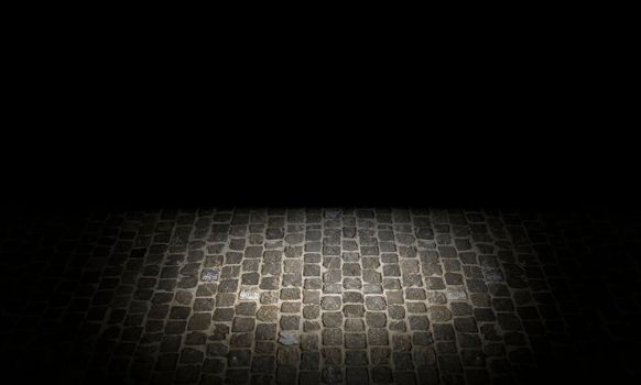 Shot of a cobblestone structure on the ground of an urban street in grey and textured tones.