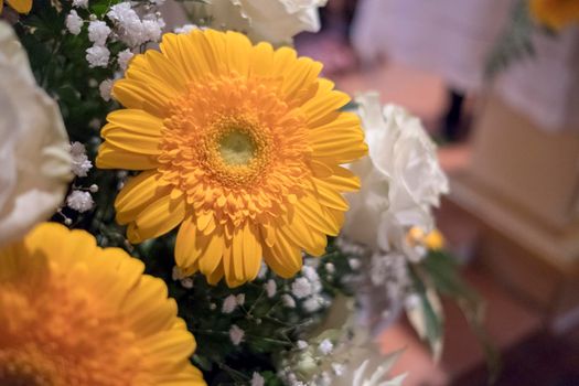 floral decoration with orange and white gerberas for wedding banquet