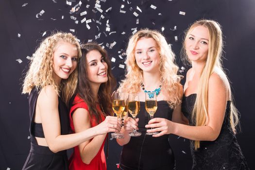 Party, new year and people concept - Cheerful young women clinking glasses of champagne at the party