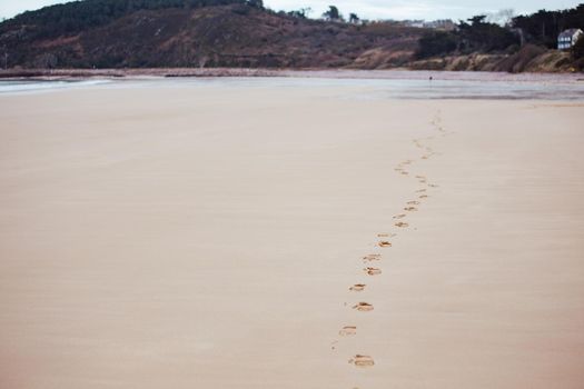 Footprints on the sand at low tide