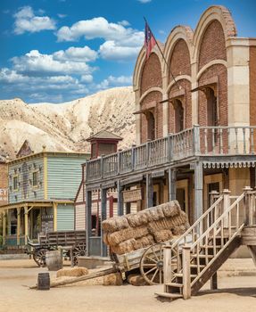 Vintage Far West town with saloon. Old wooden architecture in Wild West.
