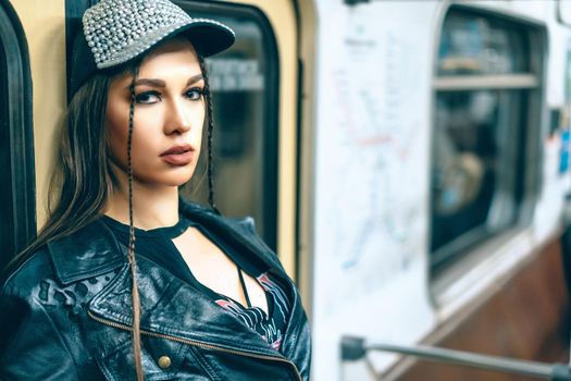 Punk -girl in Rock Style Fashion Gazes to the Camera. Woman Passenger in a Subway Car. Close-up