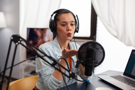 Woman influencer blowing kiss on microphone