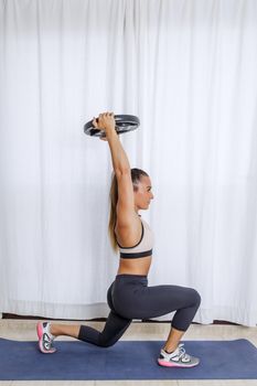 Strong woman training with weight plate