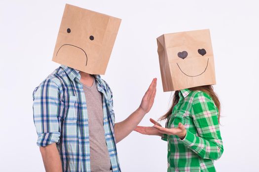 disappointed man with bags over heads rejecting his woman.
