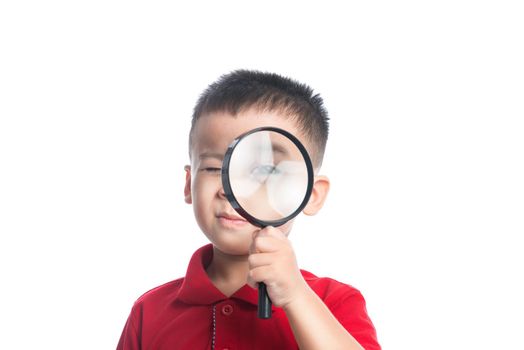 Portrait asian child looking through magnifying loupe