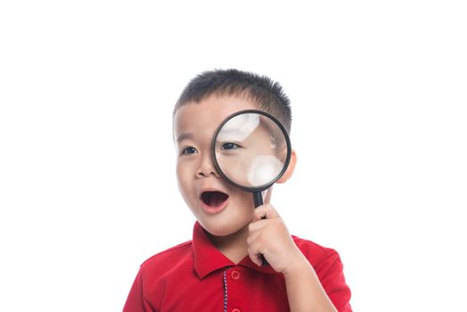 Portrait asian child looking through magnifying loupe