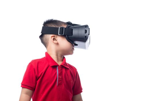 Amazed little asian boy looking in a VR goggles and gesturing with hands isolated on white background