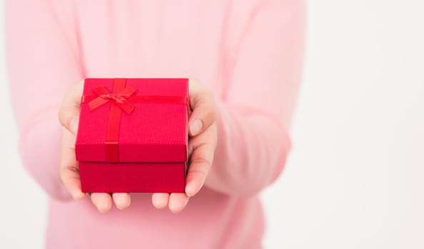 Female beauty hands holding small gift package box present