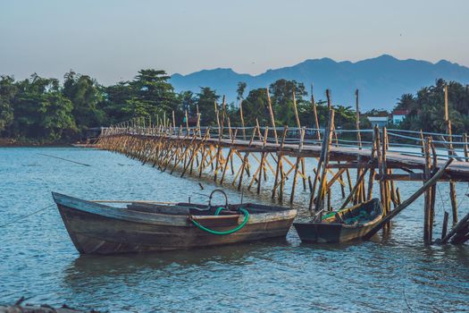 Old wooden bridge and wooden boat in Vietnam