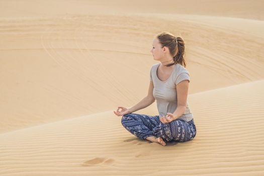Young woman meditating in the desert
