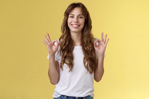 I am fine thanks asking. Cheerful relaxed smiling good-looking caucasian woman show okay rings gesture satisfied great condition recommend perfect company services stand yellow background