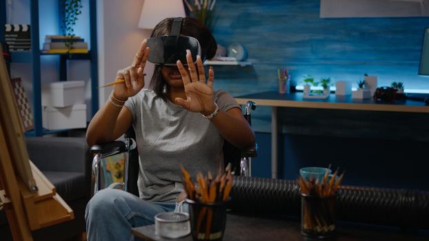 Woman artist of african american ethnicity using vr glasses