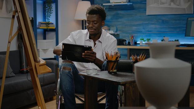 African american man with disability using digital tablet