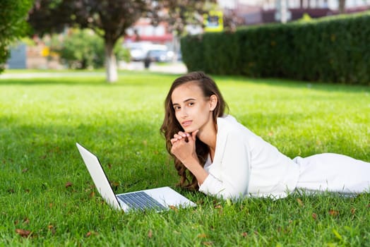 young woman and laptop in the park