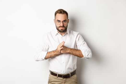 Angry man crack knuckles, want to punch someone, standing mad against white background