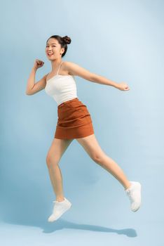 Full body photo of cheerful excited energetic girl jump enjoy spring free time holiday weekend isolated over bright color background